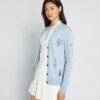 Kaschmir-Strickjacke mit Golf-Applikationen Kaschmir-Strickjacke mit Golf-Applikationen